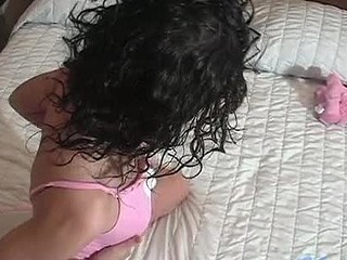 Watch this gal roll around on the daybed and think about playing with herself