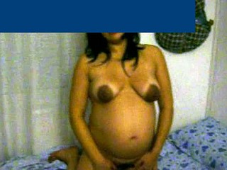 This preggy wife with beautiful cinnamon skin is about 8 months pregnant. She shows her big belly and her breasts are bare - her areolas are very dark and large.