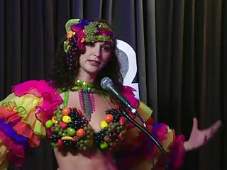 The hosts of Playboy Radio's Morning Show are looking at their guest model who is wearing the costume she'll be wearing to the Playboy Mansion for Halloween. Her head and love muffins are covered in fake fruit like oranges, limes, lemons, and more. This babe flashes her breasts for the hosts and viewers.